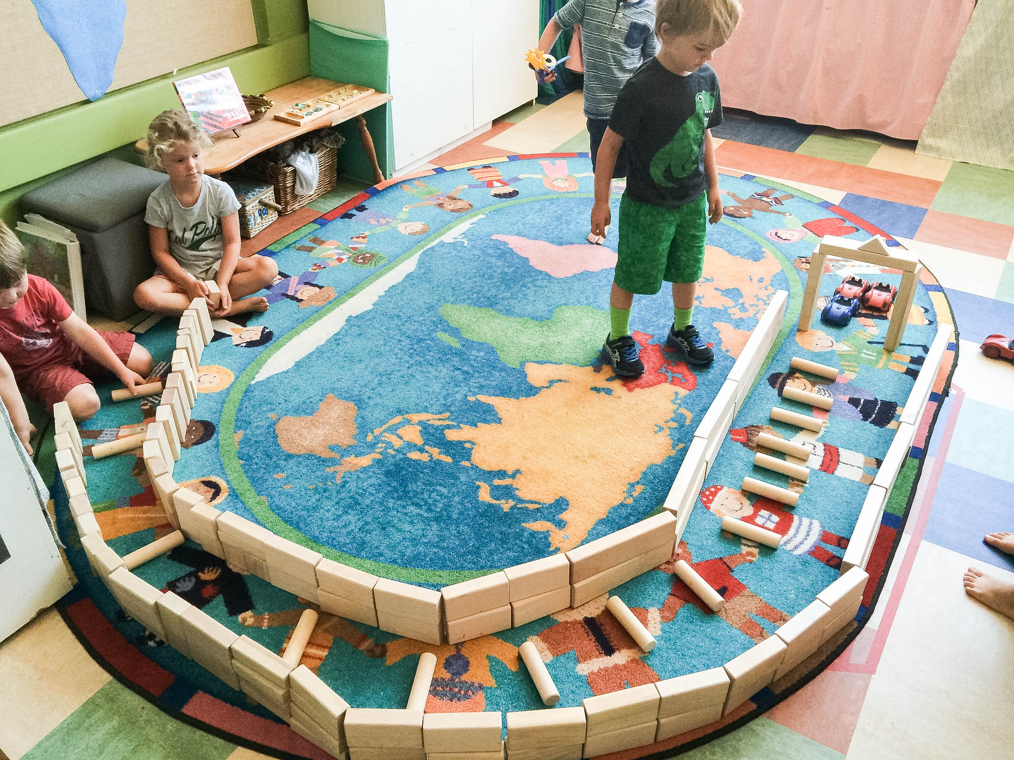 kids building with blocks on a rug